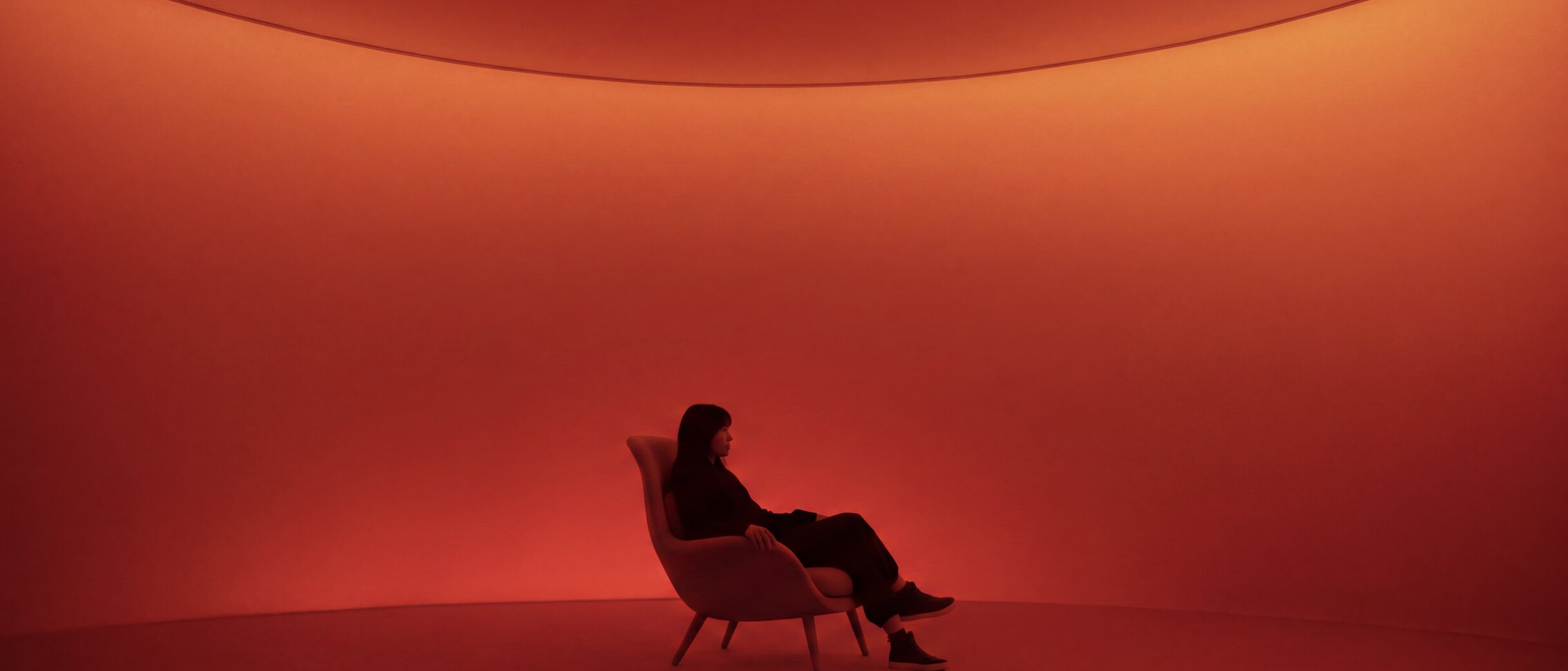 A red room with a single armchair